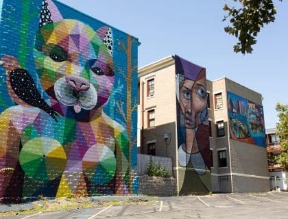 View of the colorful Cat Witch Mural on the exterior side of the Punto Urban Art Museum Building on a beautiful blue sky day in Salem MA