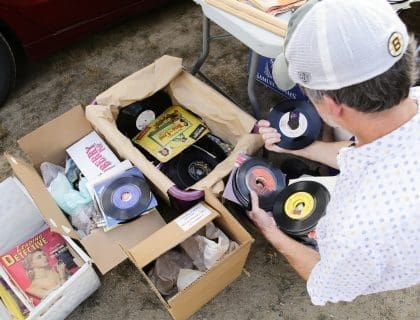 Man in Bruins Cap Rummaging through Old Records at Todd Farm Flea Market in Rowley MA