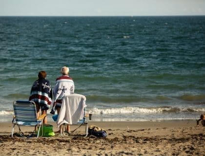 Couple Enjoying their Beach View, Sitting Close to the Water at a Beach in Marblehead