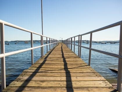 View on a beautiful clear blue sky day from the pier looking out into the water at Swampscott Yacht Club located in Fish House at Fisherman's Beach Swampscott MA