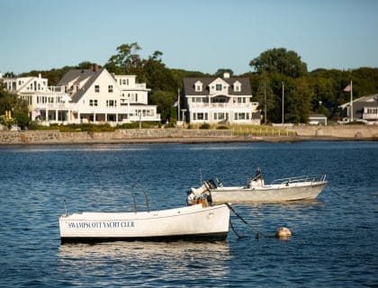The view of two small boats on a clear blue sky day in the middle of the water at Fisherman's Beach in Swampscott MA
