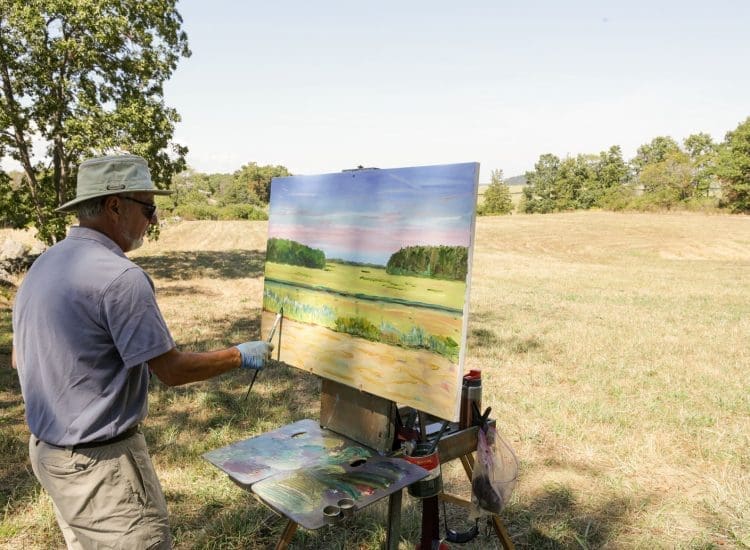 A painter painting - plein air - the marshes in Essex, MA