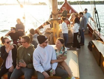 Tourists enjoy sunset on the Schooner Fame
