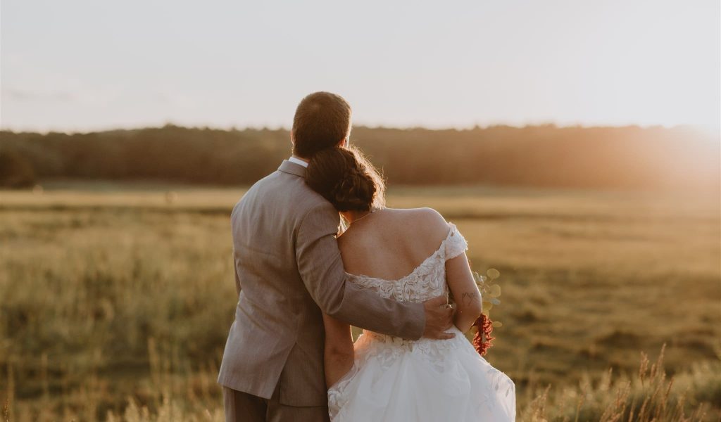 Susannah and Zachary, a wedding couple posing in the sunset