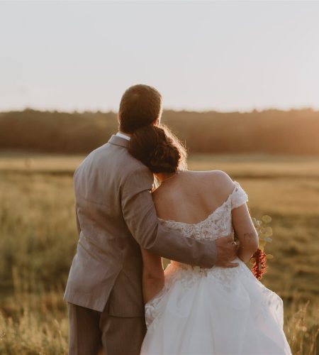 Susannah and Zachary, a wedding couple posing in the sunset
