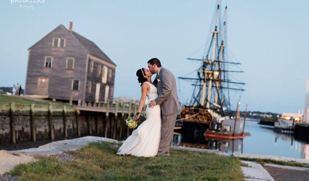 A couple poses on their wedding day at the Derby Wharf in Salem, Massachusetts
