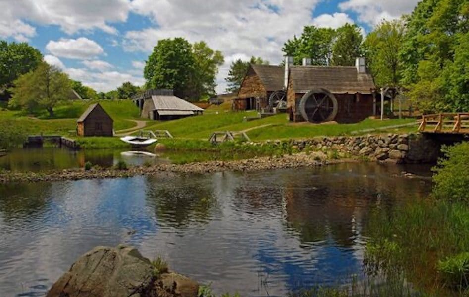 View from the water reflecting the Iron Works National Historic Site on a beautiful clear blue sky day in Saugus MA