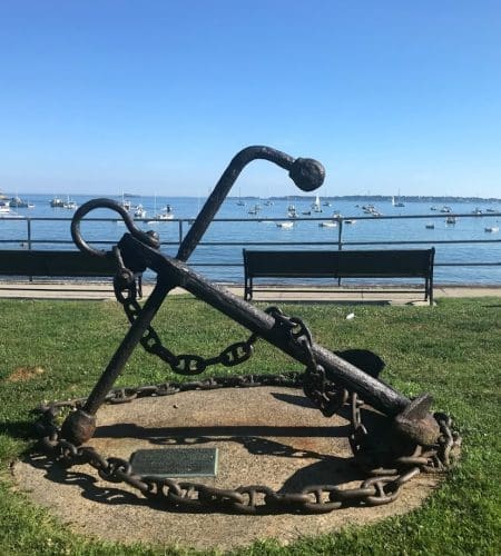 Close up of the large anchor monument in front of Fisherman's Beach on a beautiful blue sky day in Swampscott MA