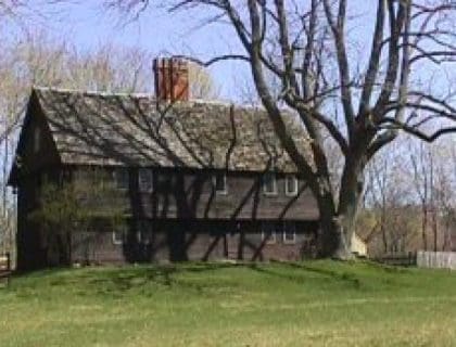 View of the front of the parson Capen House on a clear blue sky day in Topsfield MA