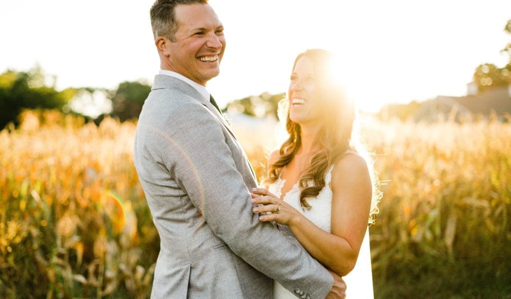 A couple on their wedding day in the setting sun with solar flare