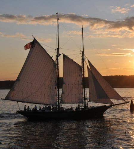A boat on the ocean at sunset