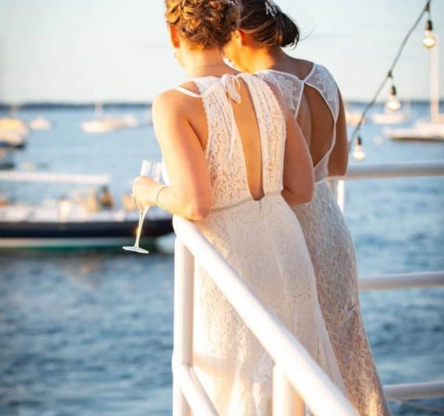 A couple posting on the Mahi Mahi boat on their wedding day