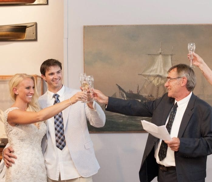 Bride and groom toasting in a gallery