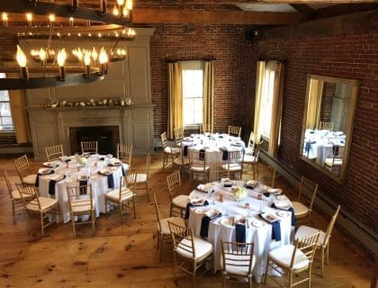 An elegant set-up of 3 round tables in the warmly lit Loft at Turner's Seafood in Salem, MA.