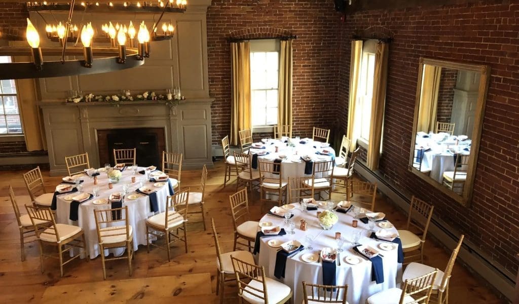An elegant set-up of 3 round tables in the warmly lit Loft at Turner's Seafood in Salem, MA.