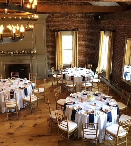 An elegant set-up of 3 round tables in the warmly lit Loft at Turner's Seafood in Salem, MA.