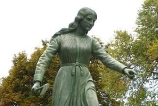Close up image of the Hannah Duston Statue in Haverhill MA on a cloudy day.