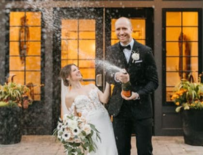 Bride and Groom celebrating and spraying champagne
